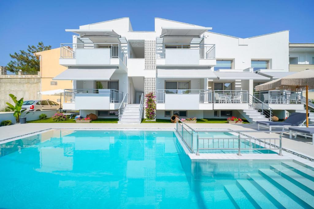 an image of a building with a swimming pool at Sourinis Luxury Suites in Limenaria