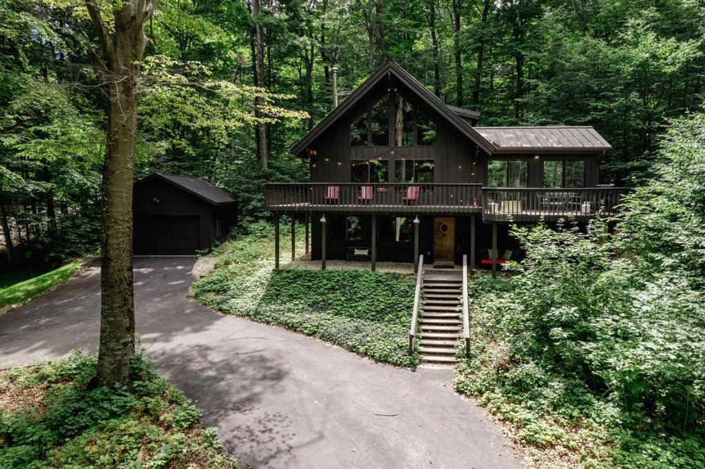a large house in the middle of a forest at Northern Nights Chalet by Wanderlust Abodes in Bellaire