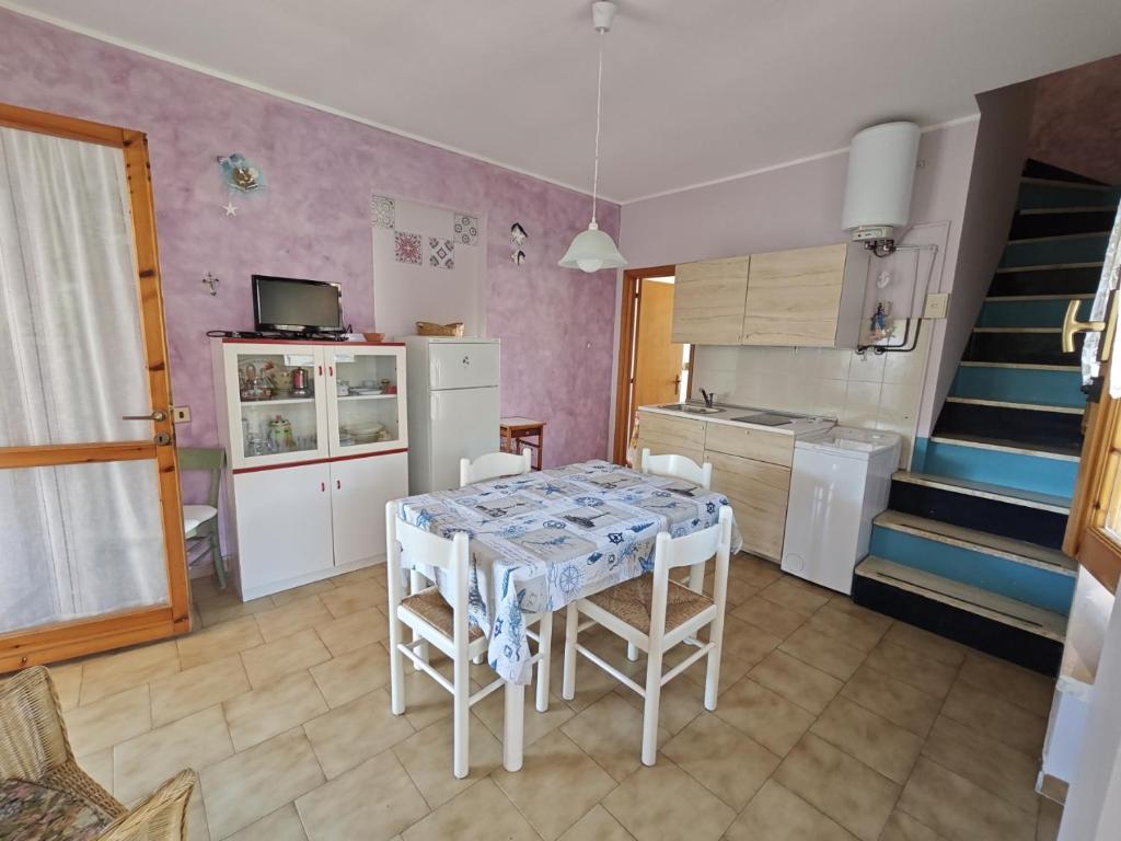 a kitchen with a table and chairs and a staircase at L06 - Trilocale a 300 mt dal mare in Ancona