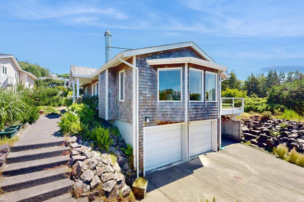 a small blue house with a white garage at Firepit Lagoon in Oceanside