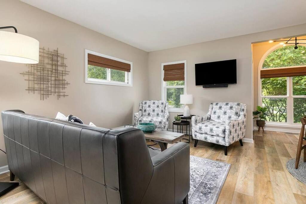 a living room with a couch and two chairs at 2min walk downtown-Pet Friendly-Offstreet Parking in Saugatuck