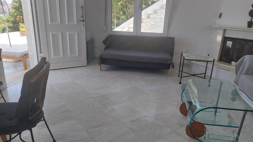 a living room with a couch and a glass table at Seaview dreams in Ormos Panagias