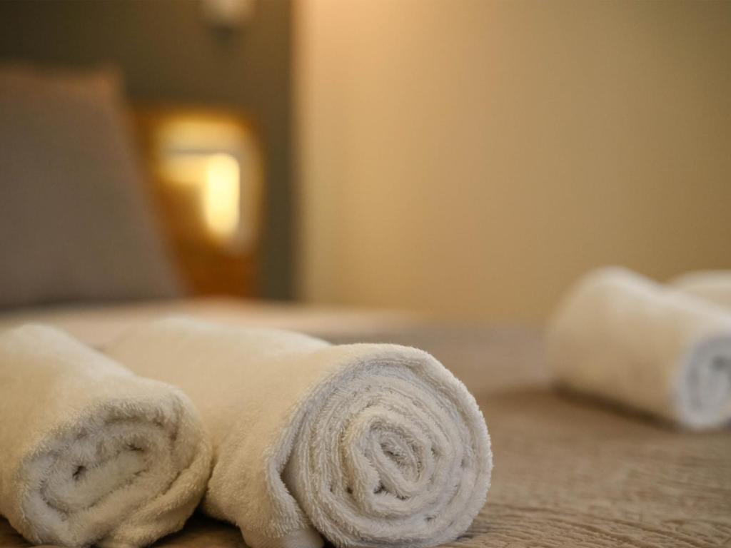 Postel nebo postele na pokoji v ubytování Zoé Suites