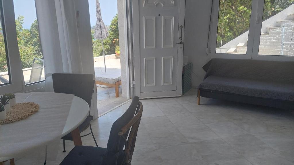 a living room with a table and chairs and a couch at Seaview dreams in Ormos Panagias