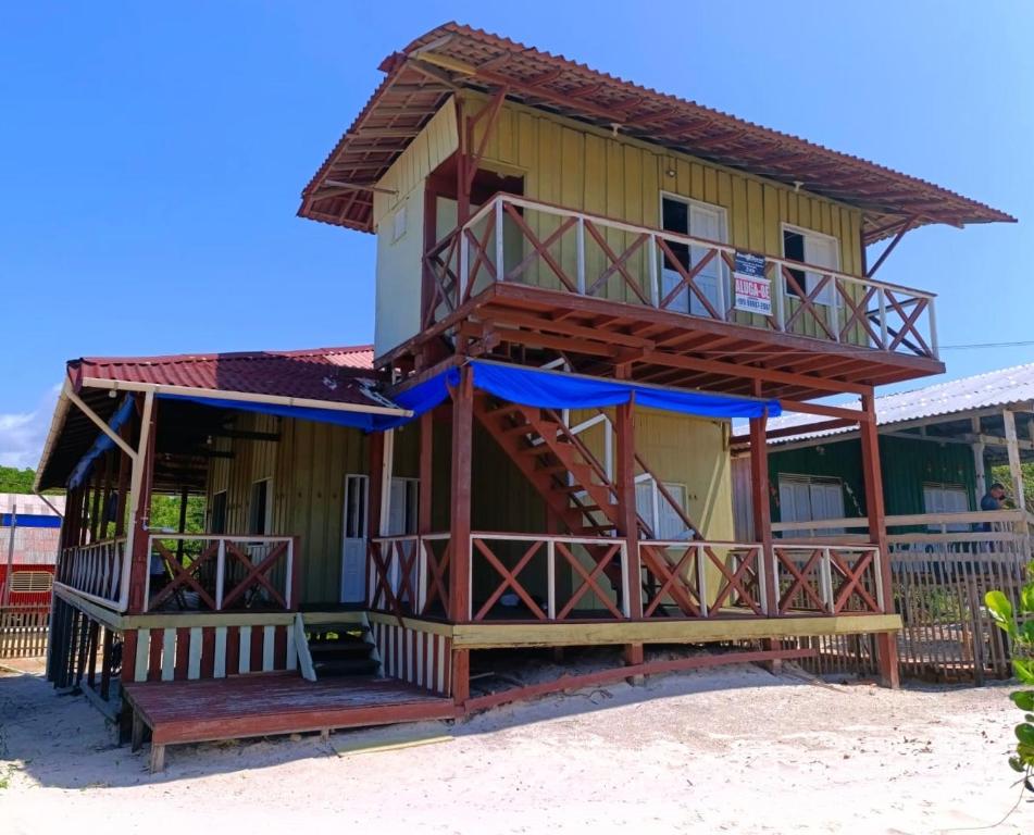 a house with a balcony on the beach at Nossa Casa de Praia in Ajuruteua
