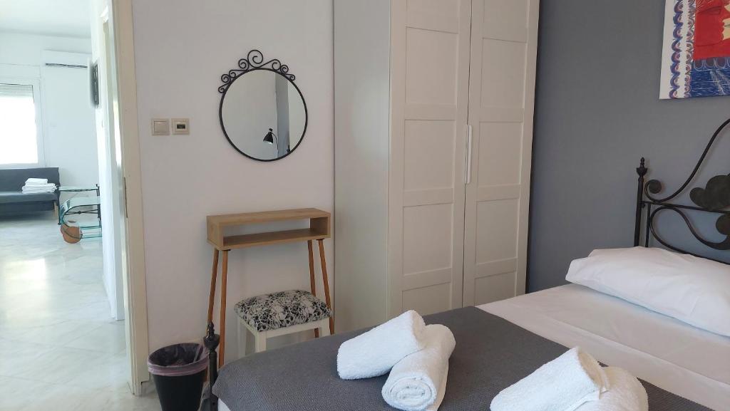 a bedroom with a bed and a mirror on the wall at Seaview dreams in Ormos Panagias
