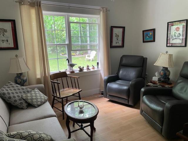a living room with a couch and chairs and a window at Harvest Moon Trail Hideaway in Middleton