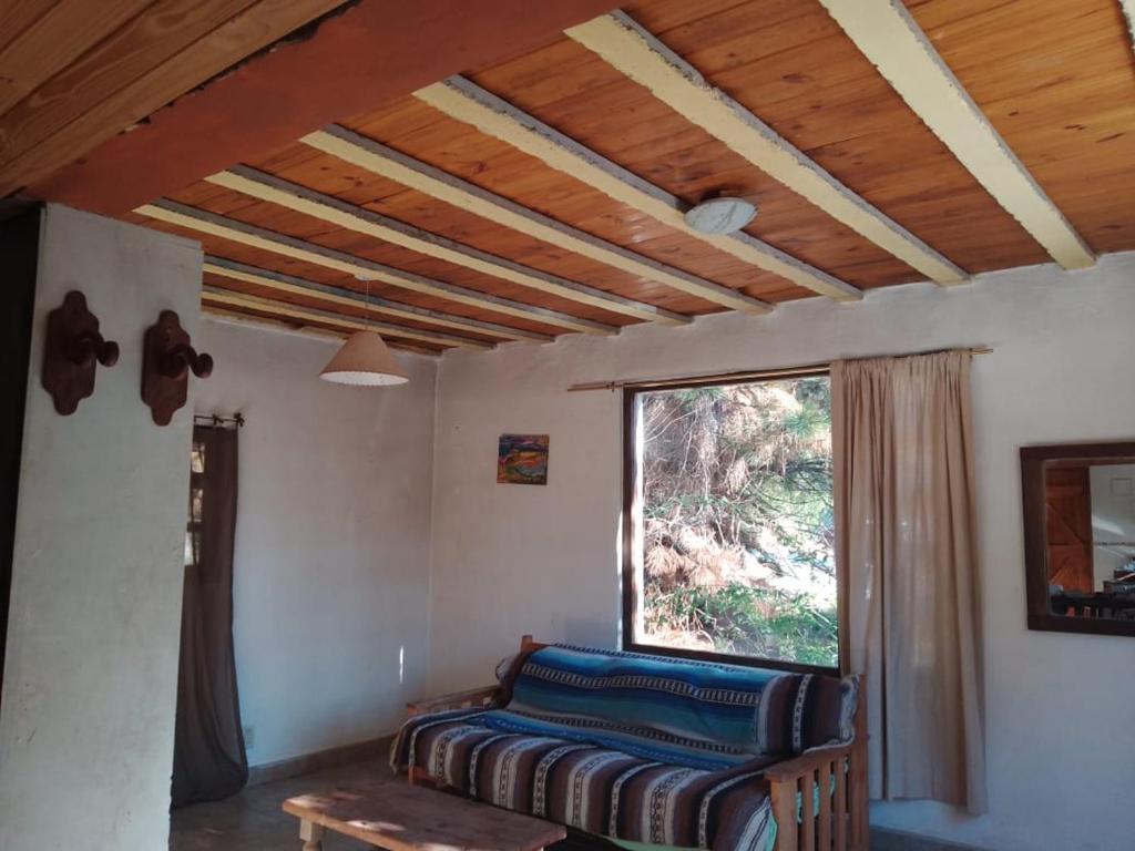 a living room with a couch and a window at Casa Blanca in San Carlos de Bariloche