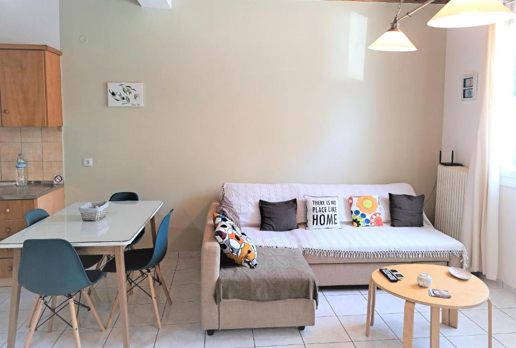 a living room with a couch and a table at Stone Family Home Garden Center Beach in Kyparissia