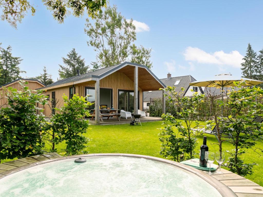 a backyard with a pool and a house at Eefs Huusje in Krachtighuizen