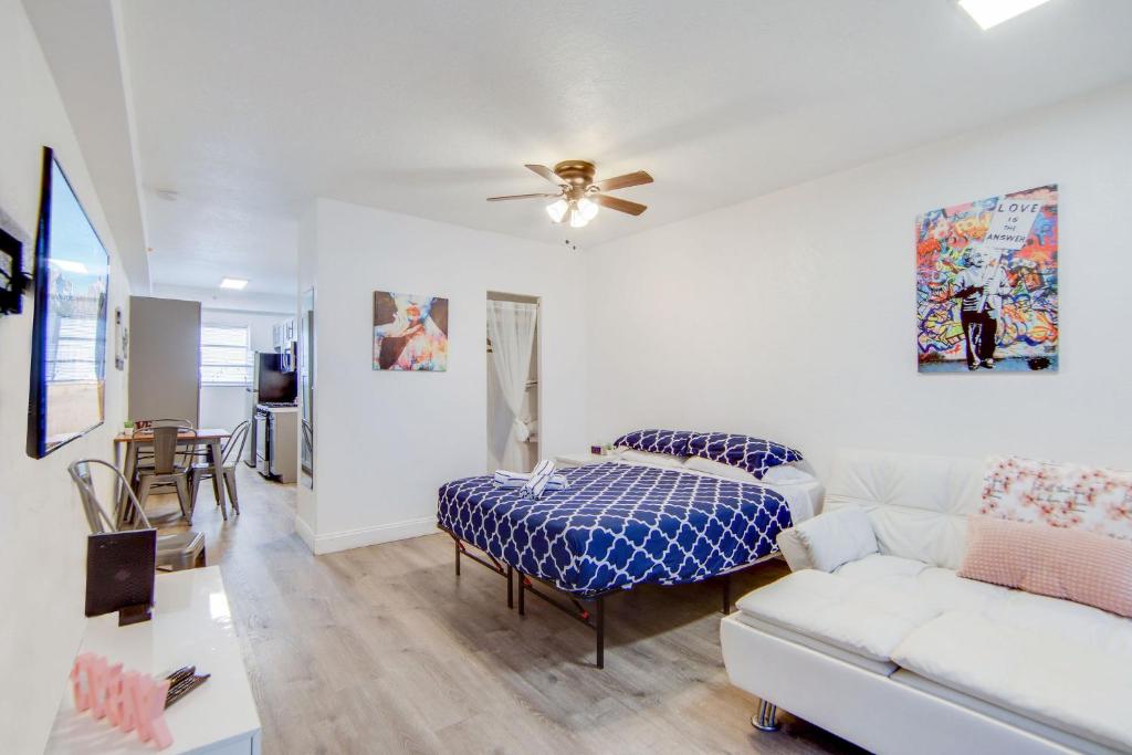 a living room with a couch and a bed at Private Ocean Dr Apt w/2 Queen Beds, Steps 2 Beach in Miami Beach