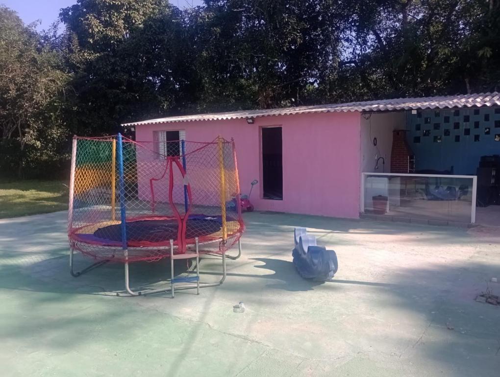 a building with a playground in a parking lot at Rancho Ohana in Peruíbe
