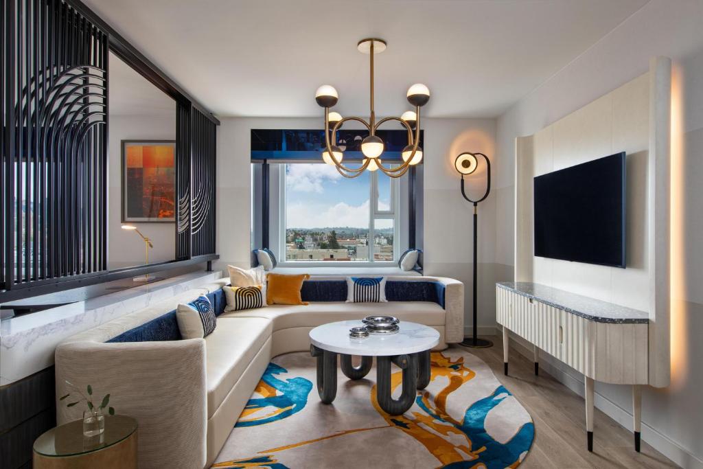 a living room with a couch and a table at W Hollywood in Los Angeles