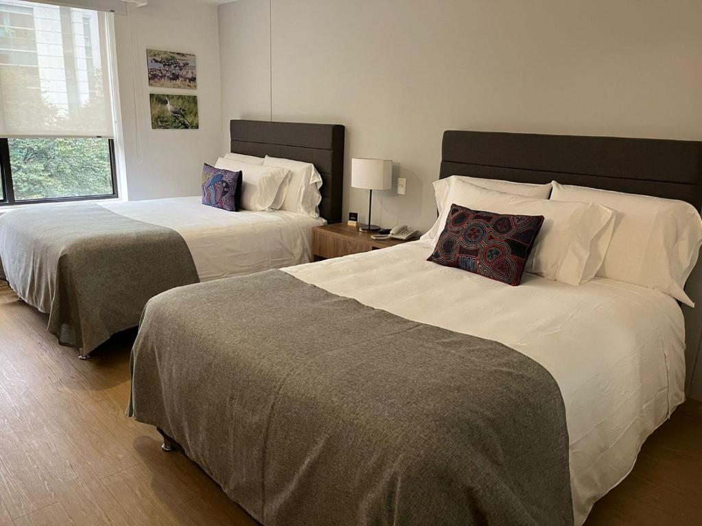 Postel nebo postele na pokoji v ubytování Hotel Parque 97 Suites