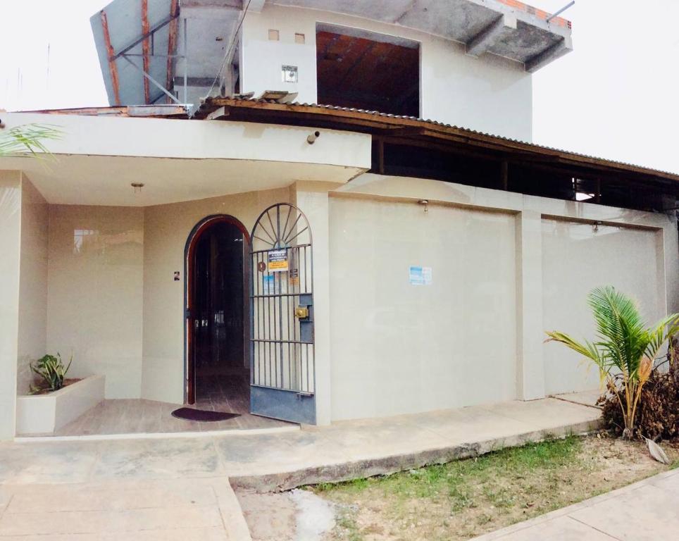 a house with a gate on the side of it at Savie Inn in Pucallpa