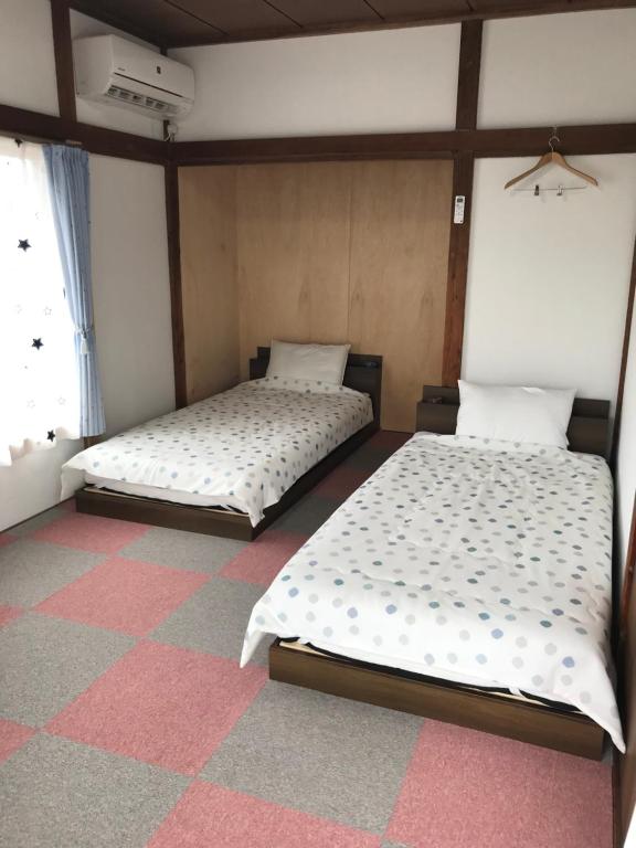 Postel nebo postele na pokoji v ubytování Guest House Ken-Ken
