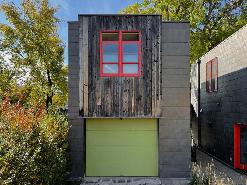 een gebouw met een garage met een rood raam bij Stunning Modern Apartment, One Of A Kind! in Bozeman