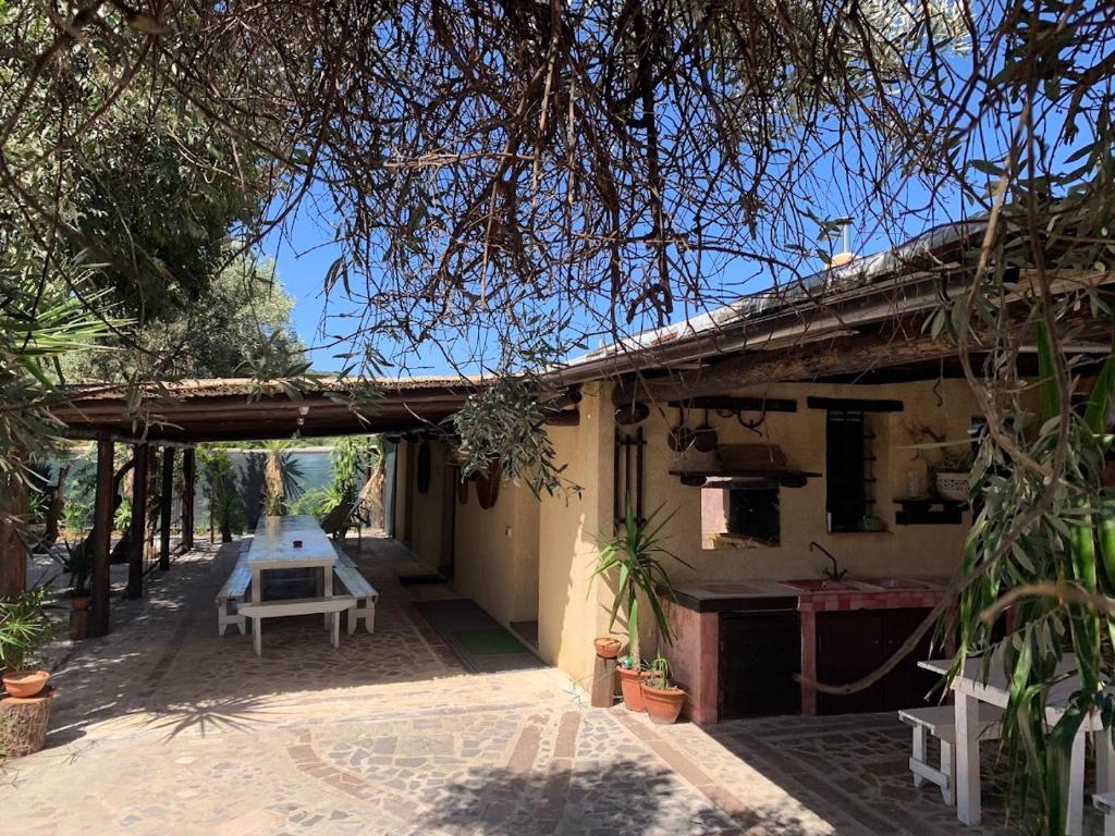 a patio of a house with a picnic table at Villa Mia in Seneghe