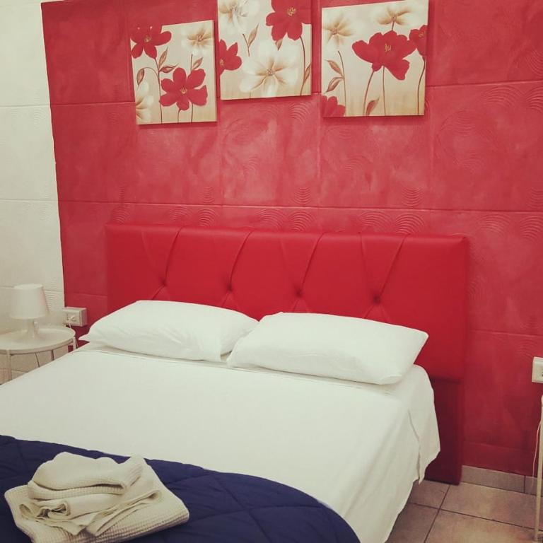 a red room with a bed with a red wall at B&B La Casetta in Cerignola