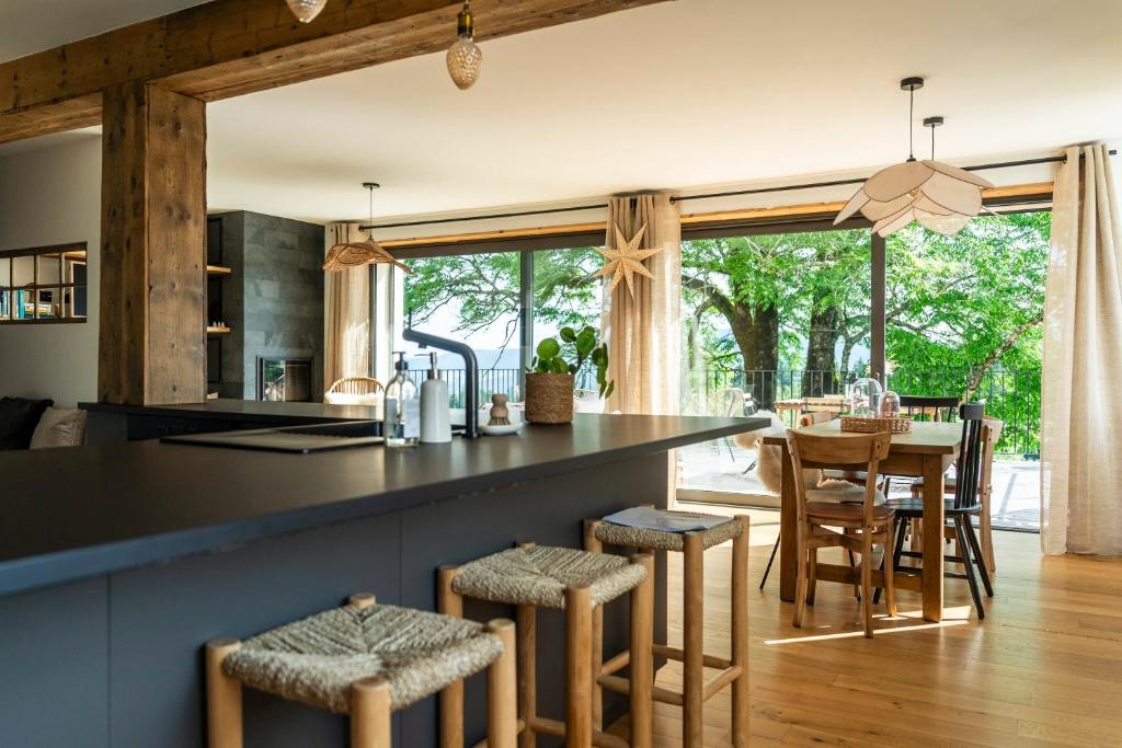 une cuisine avec un comptoir et une table avec des chaises dans l'établissement Gite d exception avec vue panoramique 4 personnes, à Prémanon