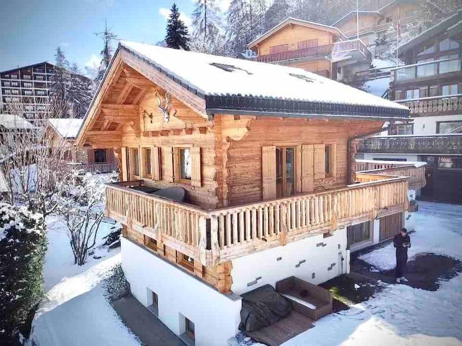 a log cabin with snow on the roof at Chalet avec vue in Nendaz