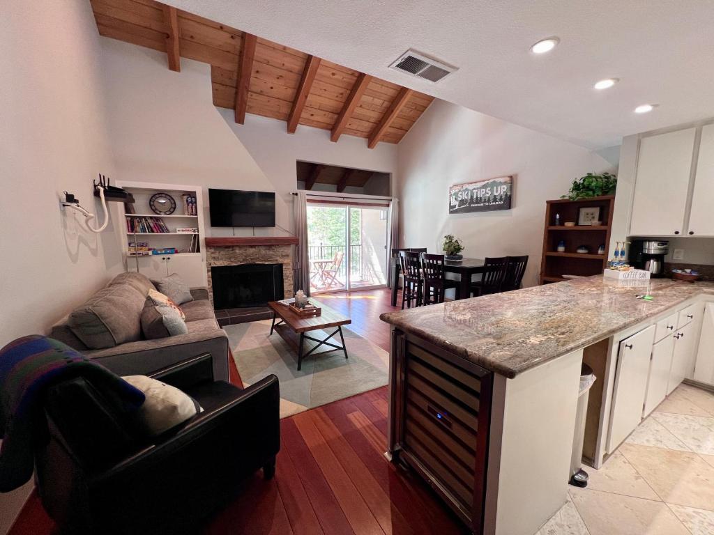 a kitchen and living room with a couch and a table at Alpine Escape: Tahoe Oasis Steps from Lake in Carnelian Bay
