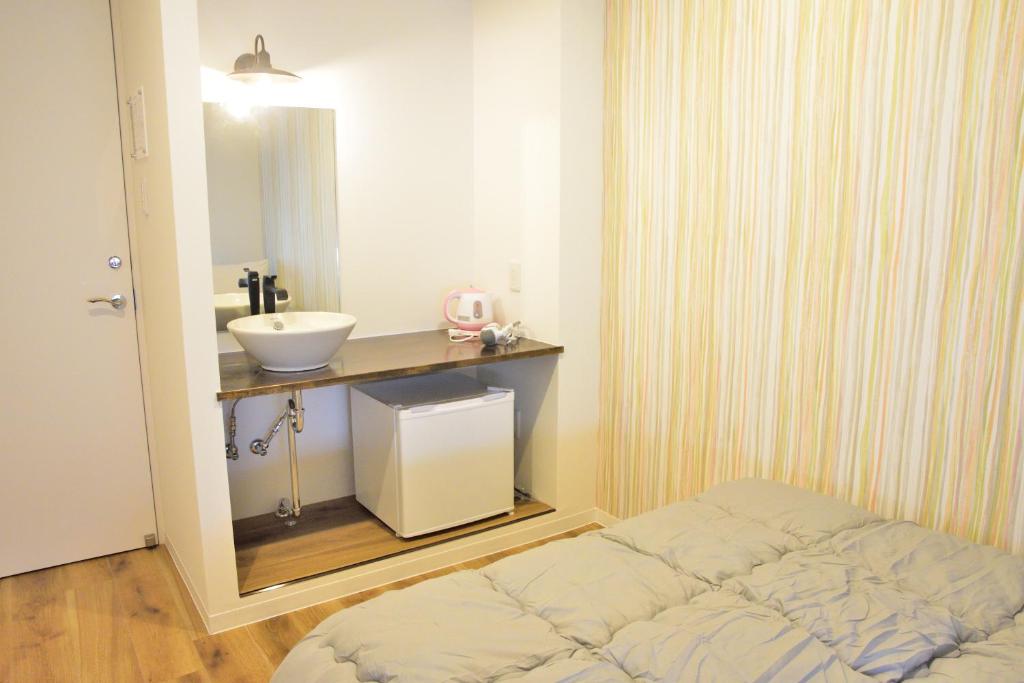 Postel nebo postele na pokoji v ubytování Hostelコトヒラクラスカ