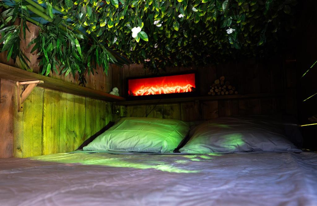 a bedroom with a bed with a fire above it at Les Chambres de Paulette à Theme LA JUNGLE ROOM in Sainte-Marie-la-Mer