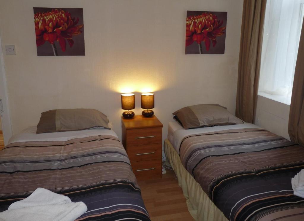 Postel nebo postele na pokoji v ubytování Arbour Guest House