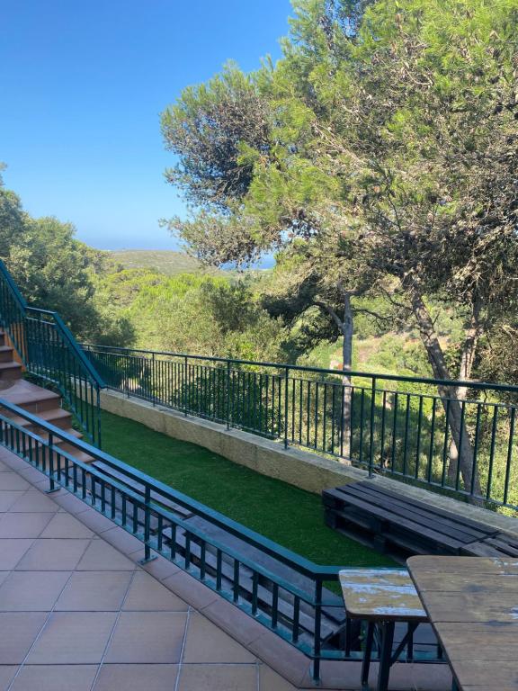 a bench sitting on top of a balcony at Amazigh Guincho Hostel & Suítes in Cascais