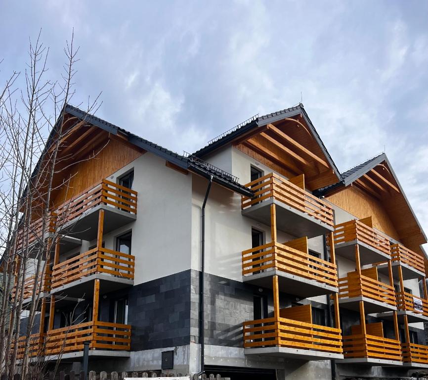 ein Gebäude mit Holzbalkonen auf der Seite in der Unterkunft Przytulny Zakątek Karkonoszy in Karpacz