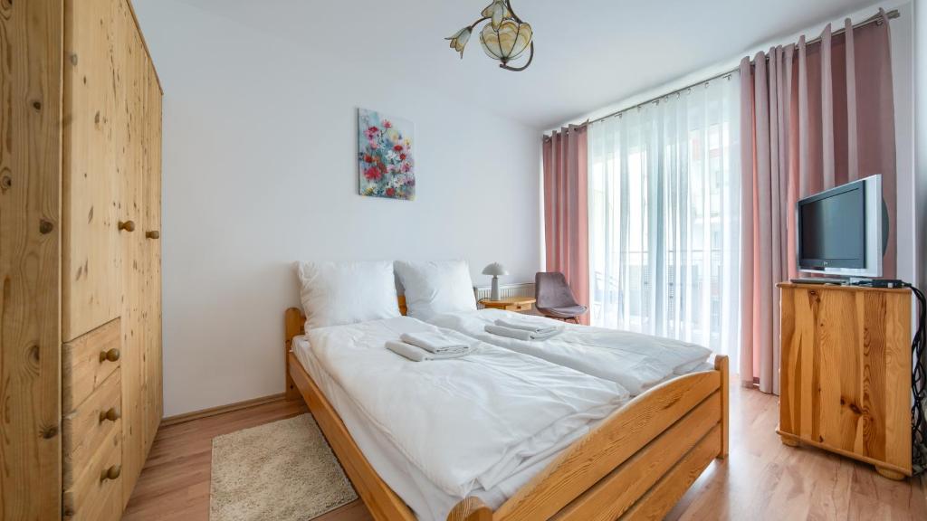 Posteľ alebo postele v izbe v ubytovaní Apartamenty Sun & Snow Kołobrzeg Jantar