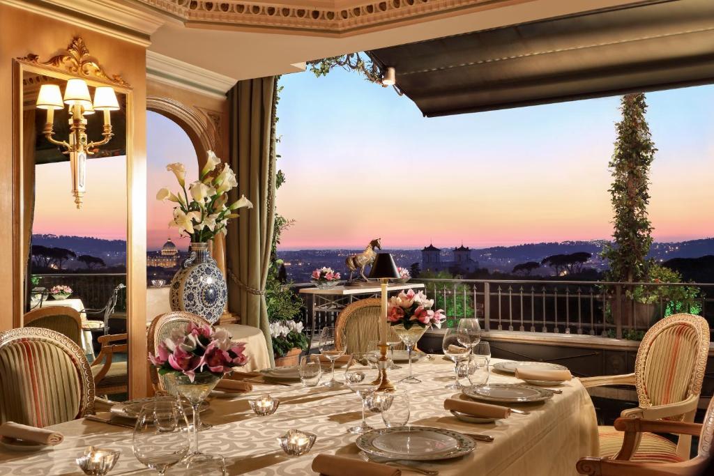 a dining room table with chairs and a large window at Hotel Splendide Royal - The Leading Hotels of the World in Rome