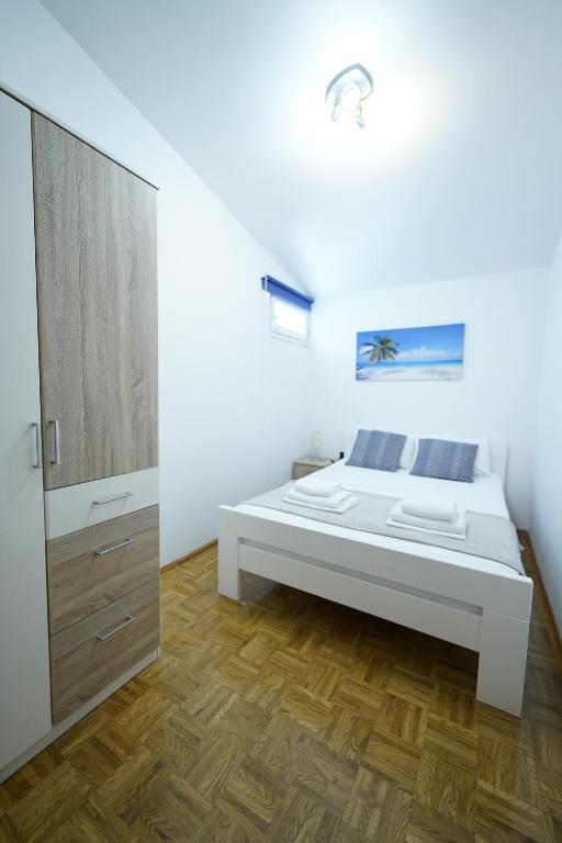 Кровать или кровати в номере Apartments Loncar-near Zrće beach
