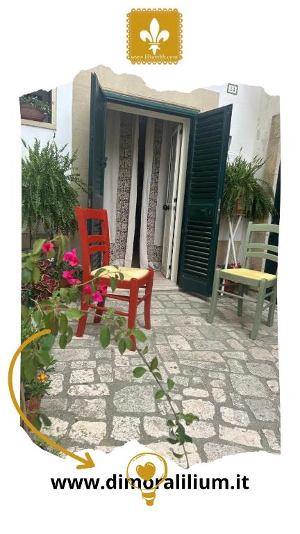 two red chairs and a table on a patio at Dimora Lilium in Otranto
