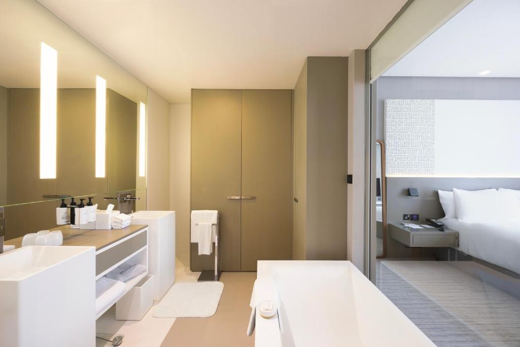 a bathroom with a bed and a sink at InterContinental Dubai Marina by IHG in Dubai