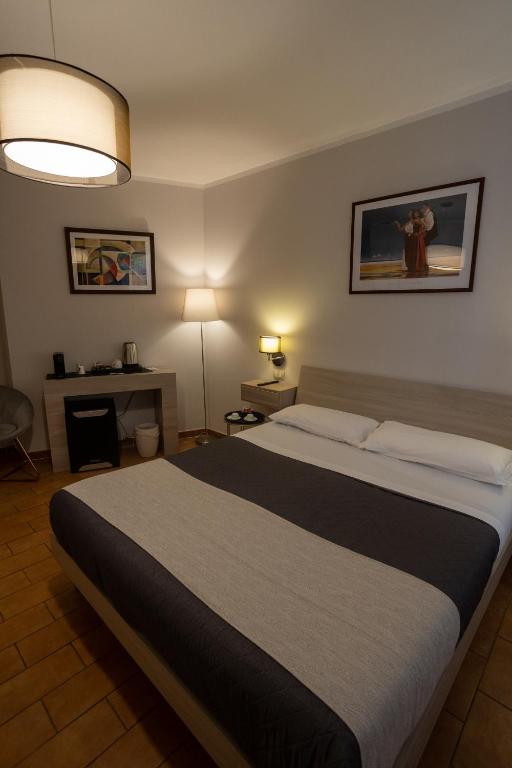 Postel nebo postele na pokoji v ubytování Helios Assisi