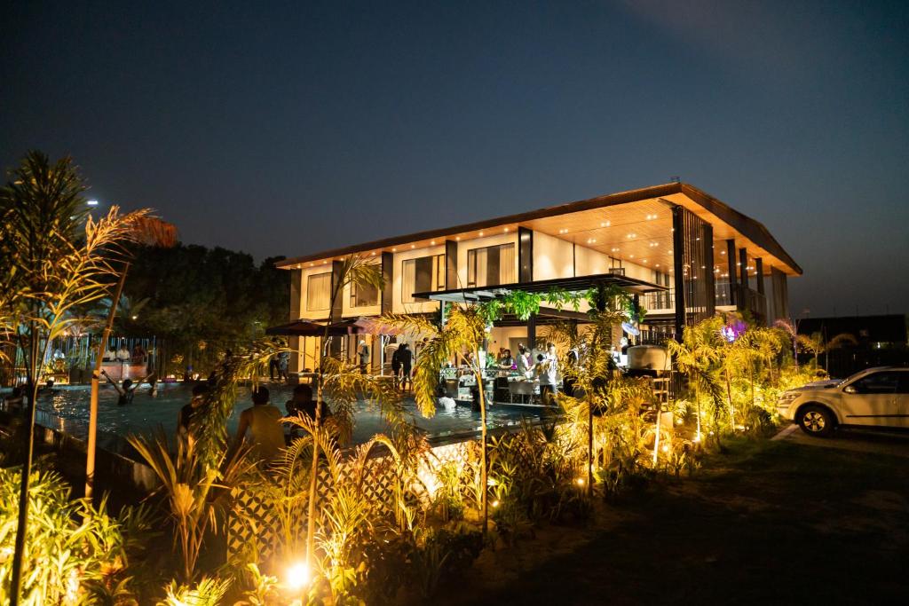 a building with a lot of lights in front of it at Vintclub Resort in Lucknow