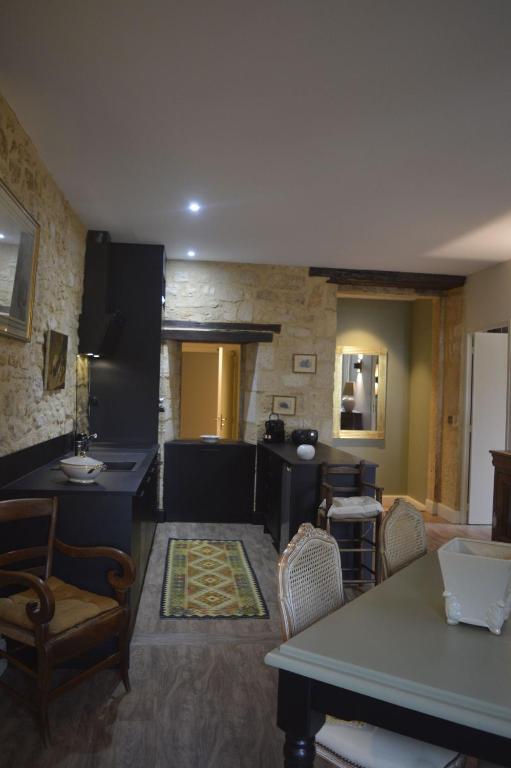 une cuisine et un salon avec une table et des chaises dans l'établissement Maison Lambert, à Domme
