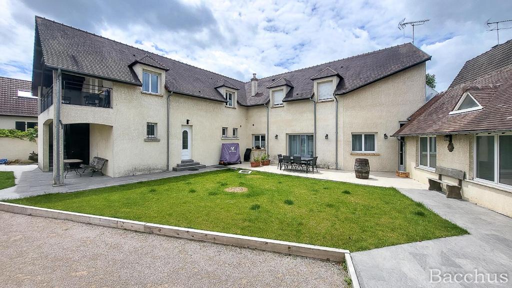 a large house with a large lawn in front of it at Gîtes Ange et Bacchus in Villecresnes
