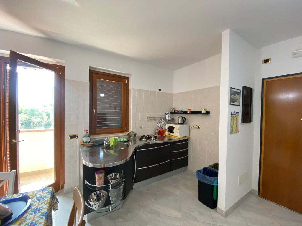 a kitchen with a sink and a counter at Appartamento estivo Tortoreto Lido prima fila in Tortoreto Lido