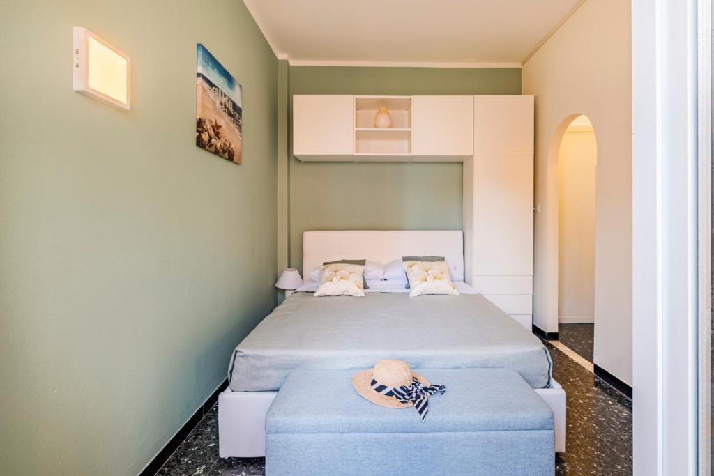 a bedroom with a bed and two blue ottomans at Sestri Levante Acquamarina in Sestri Levante