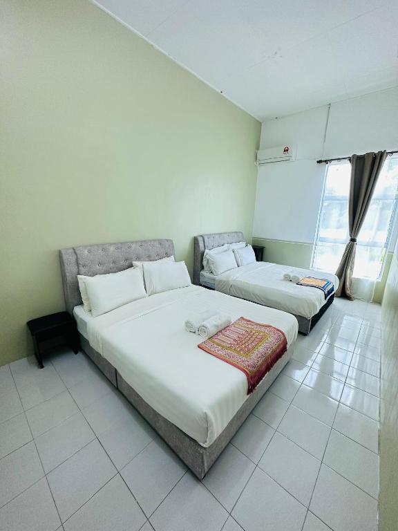 Ένα ή περισσότερα κρεβάτια σε δωμάτιο στο NOOR Serviced Apartment