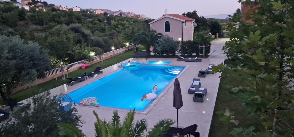 an overhead view of a swimming pool in a villa at Zvonimir Holiday with large 95m2 pool in Solin