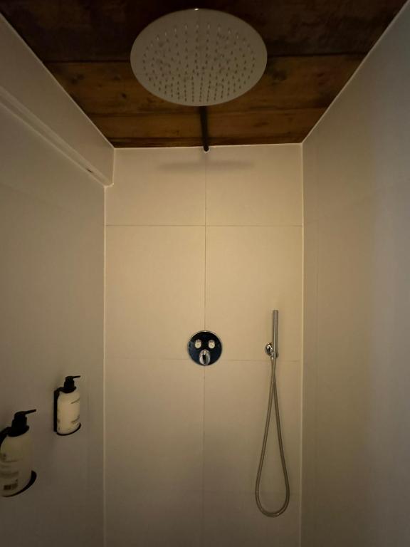 a bathroom with a clock on the wall at WS77 B&B Apartment in Leiden
