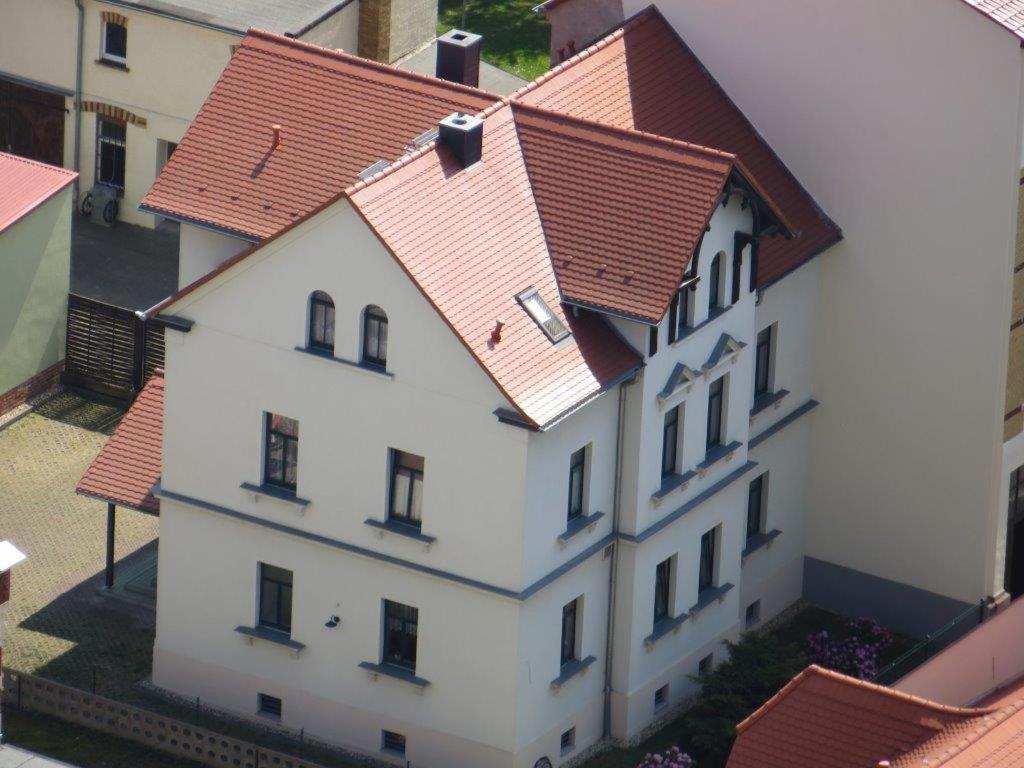 an overhead view of a white building with red roofs at Pension Schwalbe in Zwenkau