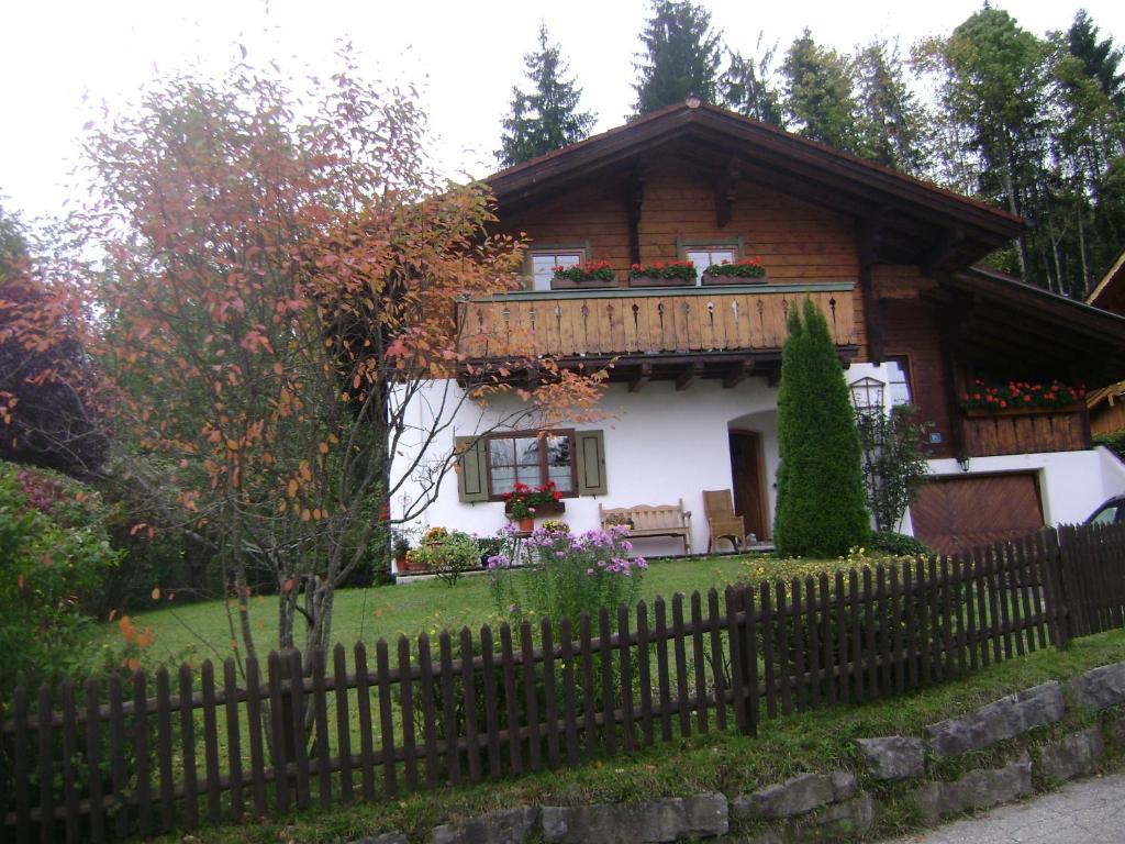 a wooden house with a fence in front of it at Ferienwohnung Wein in Berchtesgaden