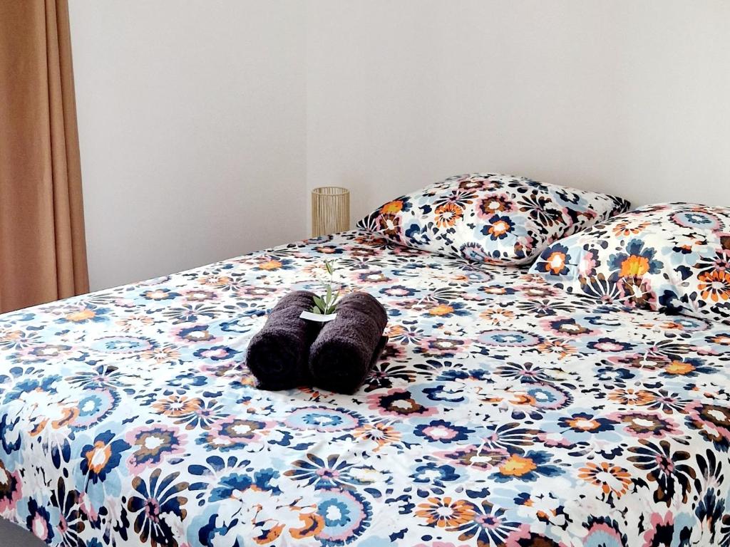 une paire de chaussures assise sur un lit dans l'établissement Résidence Confort avec Piscine - Proche des plages, à Bonifacio