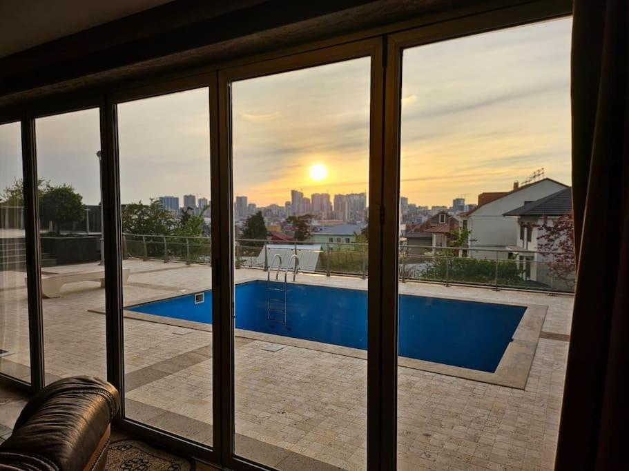 a view of a swimming pool through a window at Retro Villa in Batumi