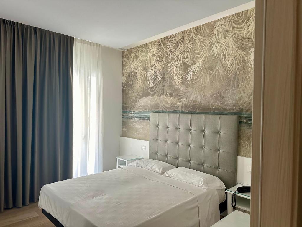 Postel nebo postele na pokoji v ubytování Hotel President